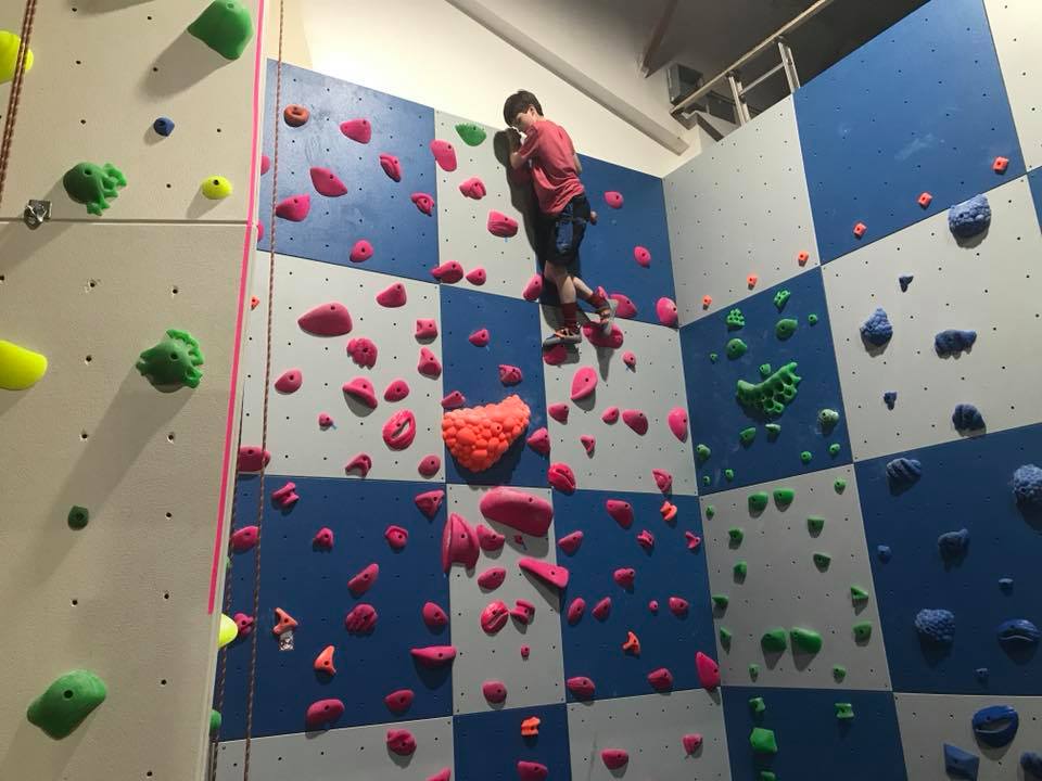 kid climbing on a home climbing wall