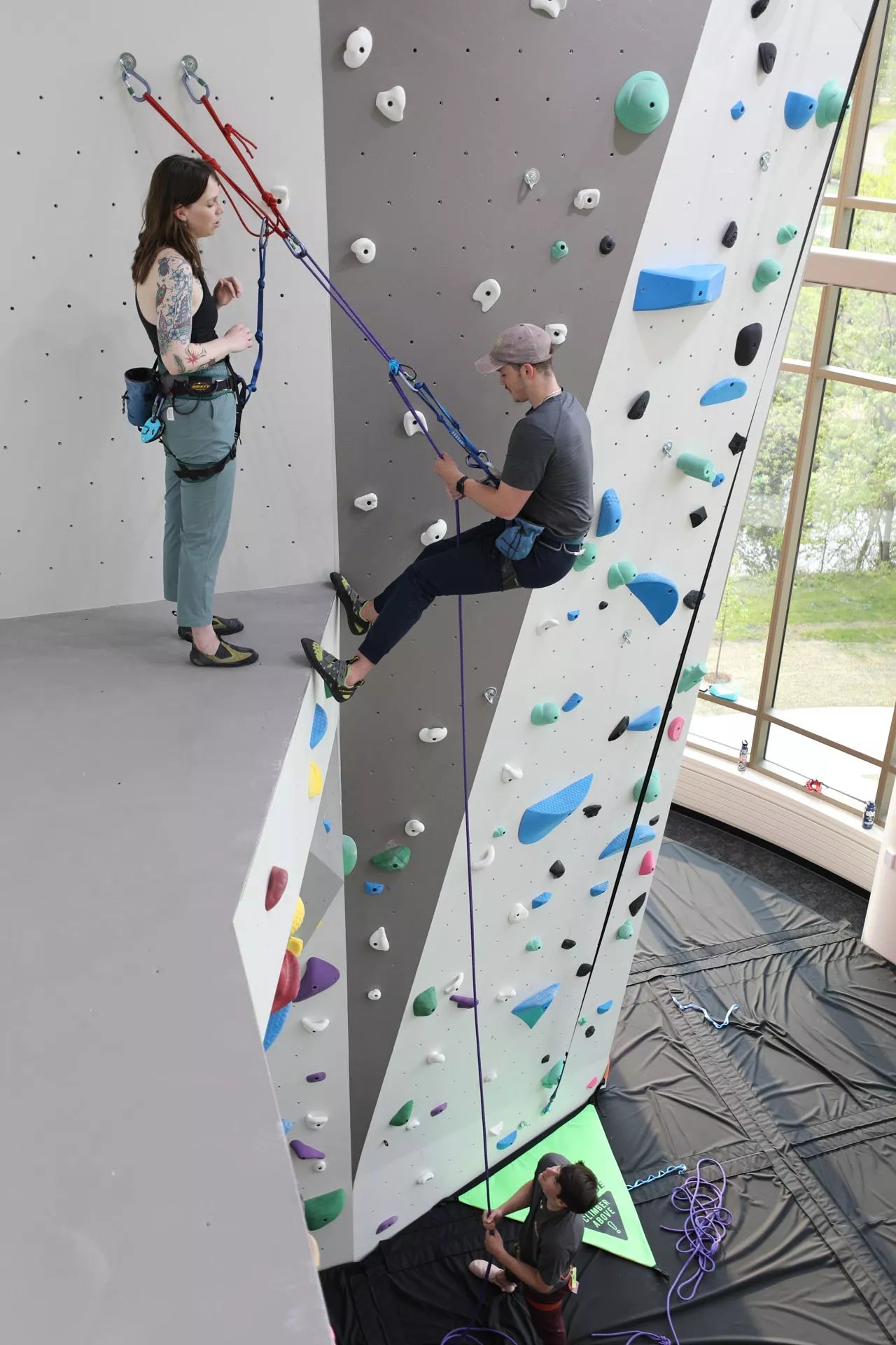 A student climbing an indoor climbing wall installed by Eldorado Walls at the University of Wisconsin-Madison